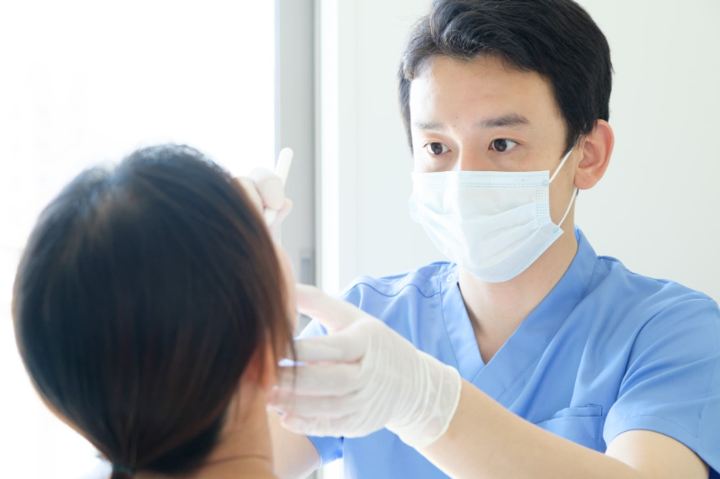 インビザラインで前歯のみを矯正するために口腔内をチェックする歯科医師